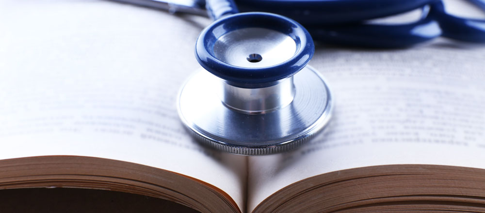 A stethoscope and book